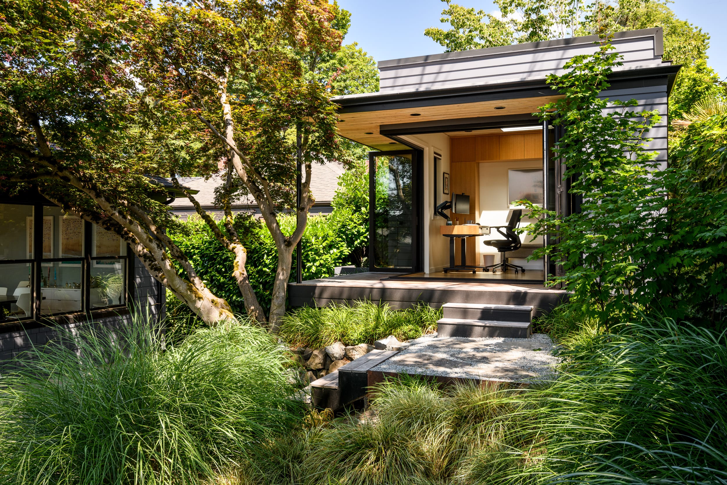 A house with a desk and a tree.