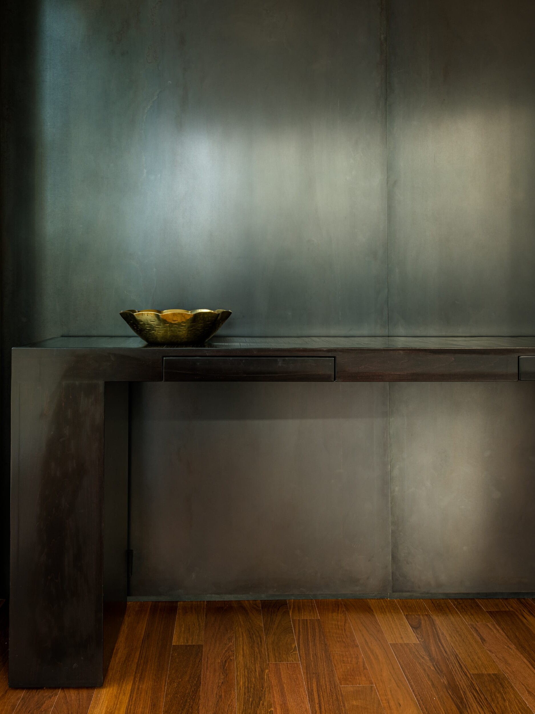 A wooden table with a bowl on it.