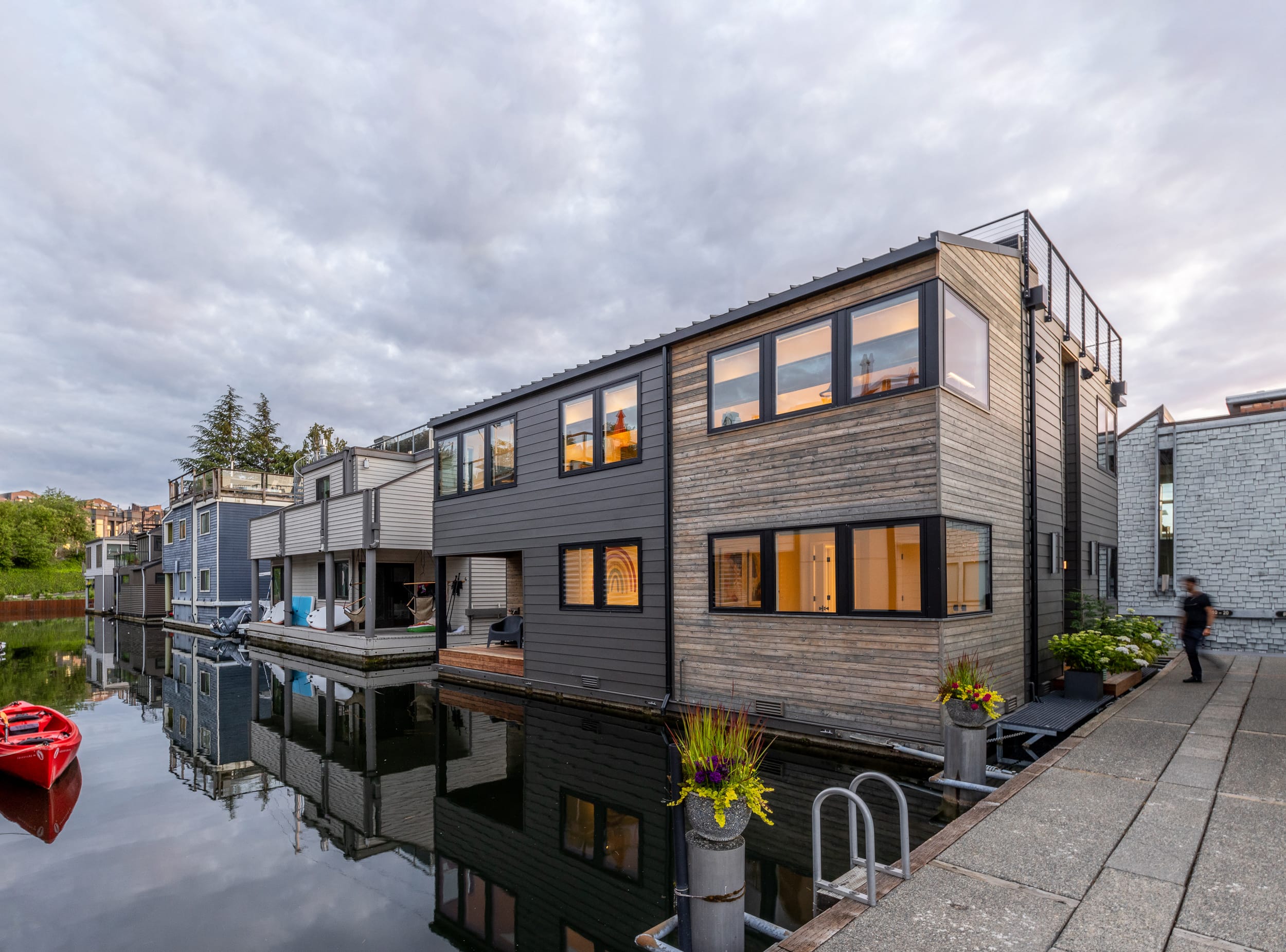 A house on a canal with a canoe in front of it.