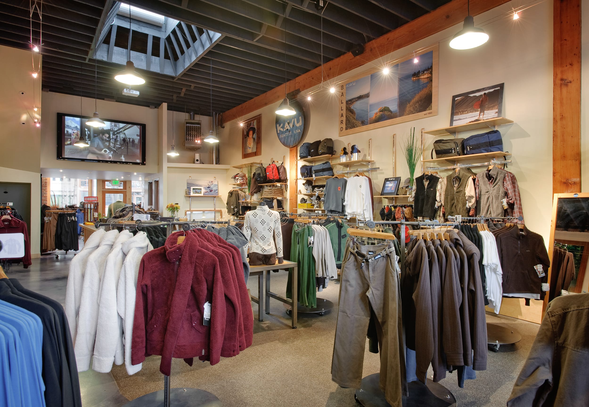 A modern clothing store with a lot of clothes on display.