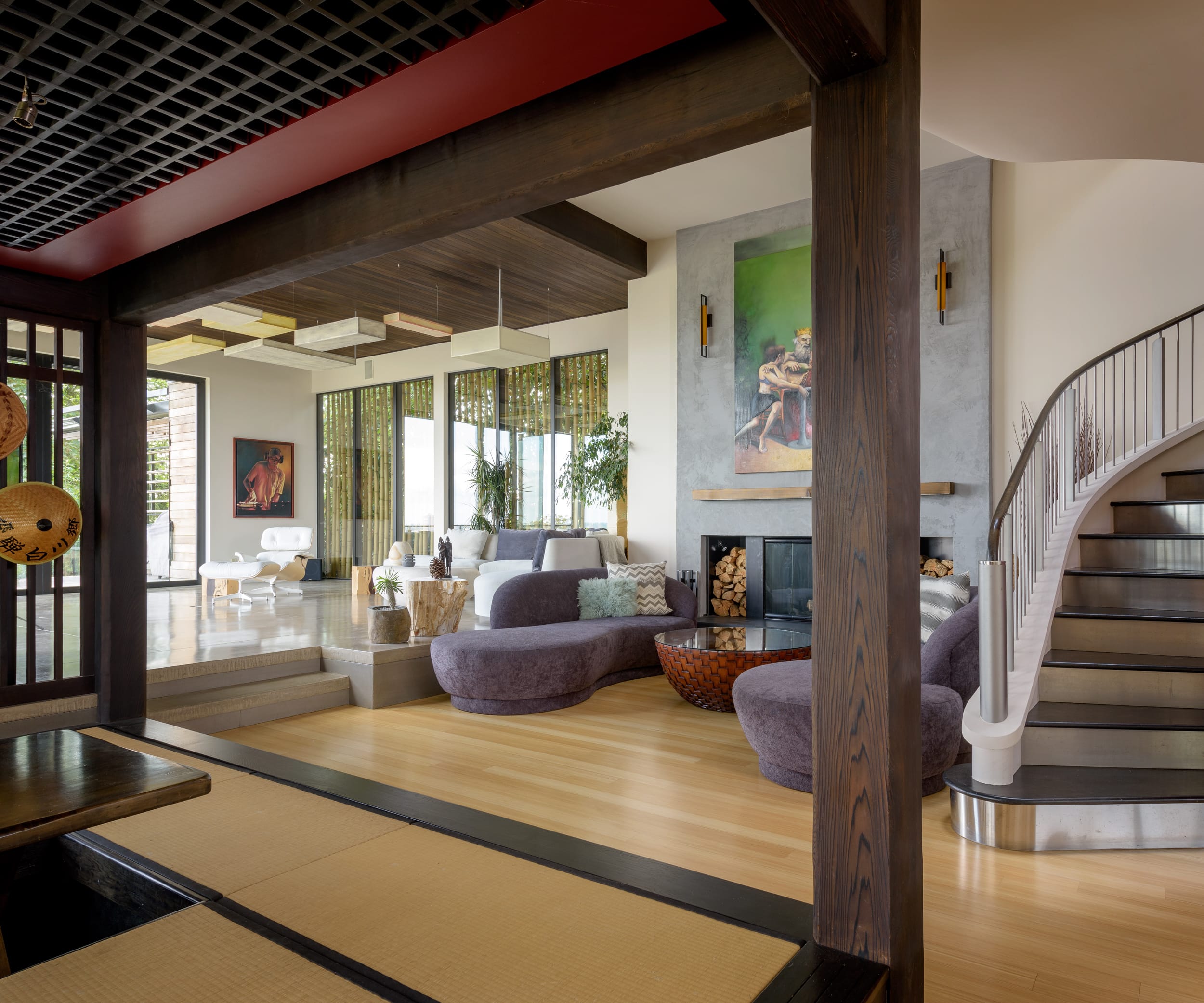 A living room with a staircase and a wooden floor.
